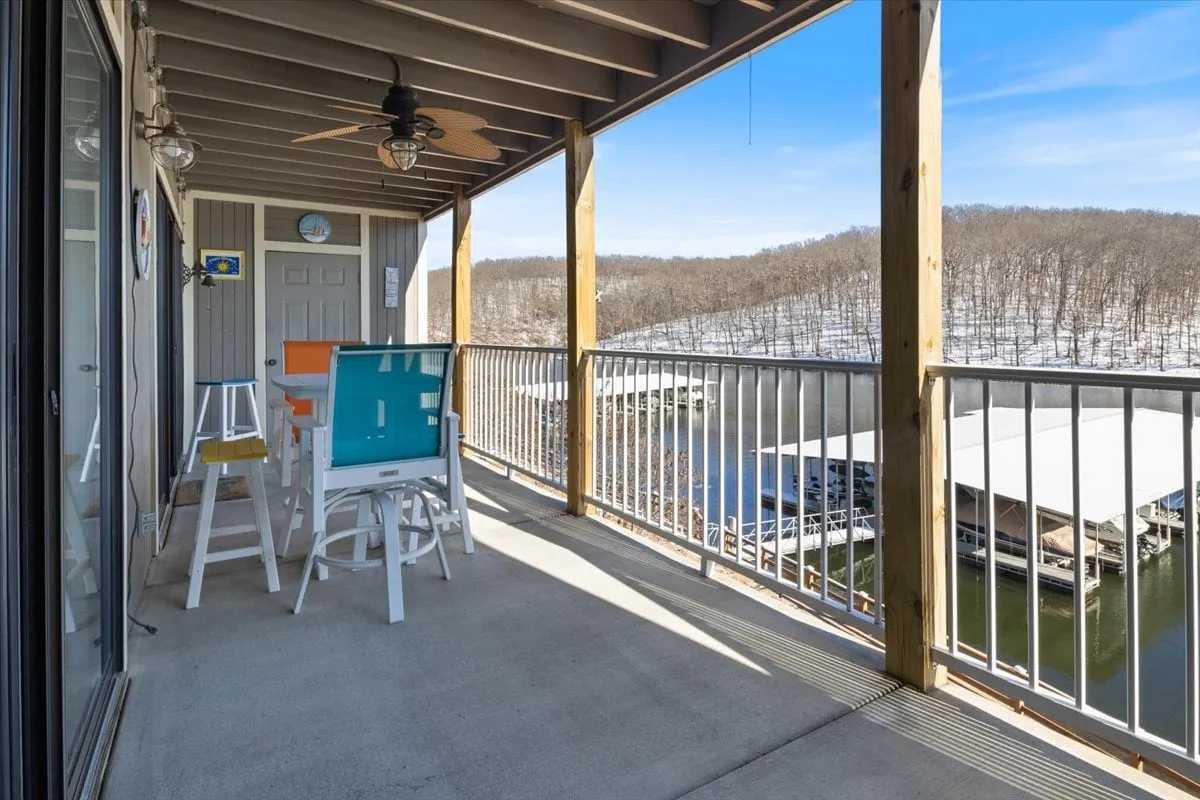 The exterior balcony scene features comfortable seating overlooking the lake and surrounding landscape. This tranquil setting is perfect for enjoying morning coffee, evening gatherings, or stargazing after a day of adventures.